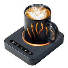 a cup of coffee with steam rising out of it on top of an electronic device