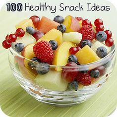 a glass bowl filled with fruit on top of a table