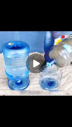 two water bottles are being filled with blue liquid