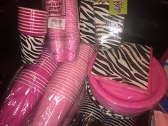 pink and zebra print party supplies are stacked on top of each other