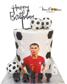 a soccer themed birthday cake with a photo on the top and two balls sitting next to it