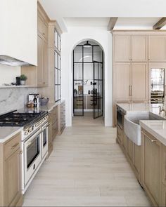 a large kitchen with wooden cabinets and white counter tops