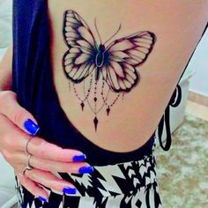 a woman's stomach with a butterfly tattoo on it