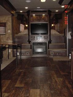 the inside of an rv with wood flooring