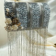 This dream bag is adorned with silver sequence, beads and  gorgeous tassels which give the bag that punch of glam that's needed for an evening look! - Comes with a detachable chain