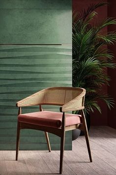 a chair sitting in front of a green wall