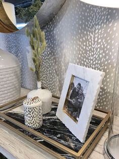 a table topped with pictures and vases filled with flowers