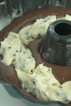 a chocolate cake with white frosting and an oreo cookie on the bottom, sitting in a pan