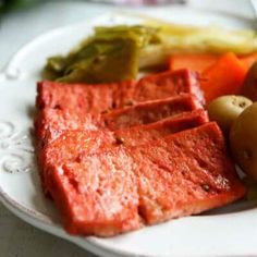 a white plate topped with meat and vegetables