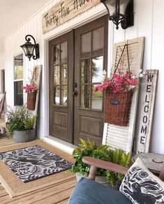 the front porch is decorated with flowers and plants