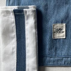 a close up of a blue and white shirt with a label on the chest pocket