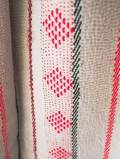 a close up view of a red, white and black pattern on a fabric material