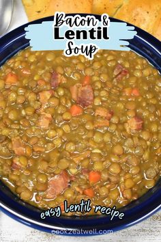 a bowl filled with beans and ham soup next to some pita bread on the side