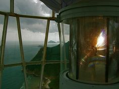 the inside of a glass observation tower overlooking the ocean