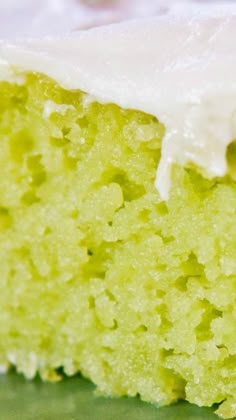 a piece of green cake with white frosting