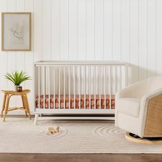 a white crib and chair in a room