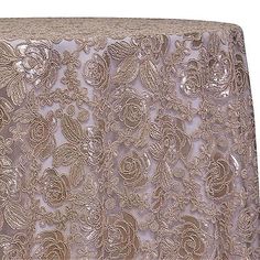 an image of a table cloth with flowers and leaves in gold on white background, close up