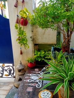 some plants and pots on a table outside