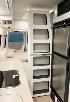 the inside of a motor home with an oven and refrigerator