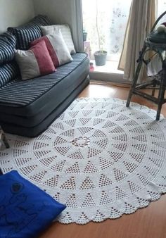 a living room with a couch, chair and rug