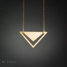 Triangle necklace - geometric triangle with V-shaped hole pendant. Featuring minimalist  silhouettes. ★ Comes in our signature gift box, ready for gift giving.  ★ Available in Gold [ gold-filled chain & gold plated brass pendant]  ★ Pendant size: 1.10"X1.80" Thanks for shopping at ByYaeli♥  All images, texts & products are property of ByYaeli ©2020 Modern Gold Geometric Necklace, Gold Geometric Minimalist Necklace, Minimalist Gold Geometric Necklace, Minimalist Geometric Gold Jewelry, Minimalist Triangle-shaped Jewelry For Gifts, Minimalist Gold Triangle Jewelry, Minimalist Triangle Jewelry For Gifts, Minimalist Triangle Gold Jewelry, Minimalist Geometric Gold Necklace