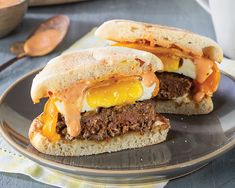 a meat and egg sandwich is on a plate