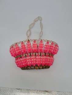 pink beaded purse hanging on the wall