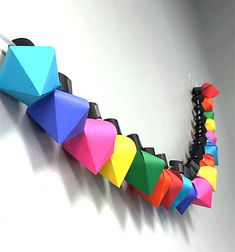 a multicolored necklace is hanging on the wall