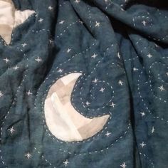 an image of a blanket with the moon and stars on it that has been stitched together