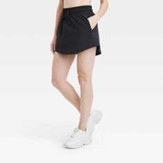 Why we're ALL IN: Woven mid-rise skort with built-in shorts in a regular-fit silhouette makes a cool choice for your active days. Moisture-wicking, quick-dry lightweight fabric helps you stay cool, while a drawcord elastic waistband provides a snug fit. Side pocket provides hands-free convenience and the UPF 50+ rating offers sun protection. All in Motion™: Made for every move, priced for every day. Moisture-wicking Short Skort For Workout, Moisture-wicking Short Skort For Gym, Solid Short Skort For Sports, Solid Color Short Skort For Sports, Sporty Short Tennis Skirt For Gym, Casual Athletic Shorts With Short Inseam For Running, Casual Athletic Shorts For Running With Short Inseam, Casual Skort With Built-in Shorts For Running, Solid Color Sports Skort