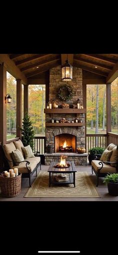 an outdoor living room with fireplace and couches