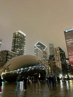 people standing in front of a large metal object