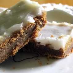 two pieces of cake sitting on top of a white plate with frosting and icing