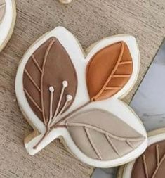 cookies decorated with leaves on top of a table