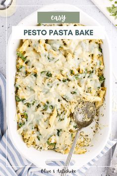 a casserole dish filled with pesto pasta and cheese