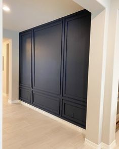 an empty room with dark blue walls and white trim on the wall is pictured in this image