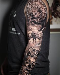 a man's arm with tattoos on it and an image of a lion in the middle