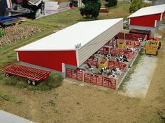 a model farm scene with cows in their stalls and on the other side of the barn