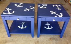 two blue side tables with white anchors painted on them