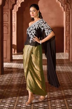 Black one shoulder top with contrasting floral vine pearl embroidery. Comes with double tone shimmer tissue draped skirt. - Aza Fashions Elegant Pre-draped Saree With Floral Embroidery, Floral Embroidered Pre-draped Saree For Party, Elegant Evening Saree With Floral Embroidery, Elegant Floral Embroidered Saree For Evening, Elegant Floral Embroidered Evening Saree, Evening Saree With Floral Embroidery, Traditional Floor-length Evening Blouse, Draped Party Dress With Intricate Embroidery, Traditional One-shoulder Fitted Dress