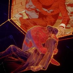 two people are sitting on the ground in front of a large screen with an image of spider - man