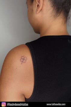 a woman with a small tattoo on her shoulder