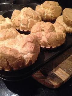 several muffins sitting on top of a black tray