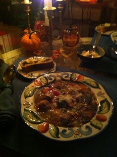 a dinner table set for two with food on it