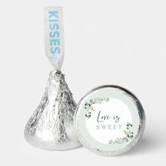 two silver foiled herss with the word live's sweet on it and a white ribbon