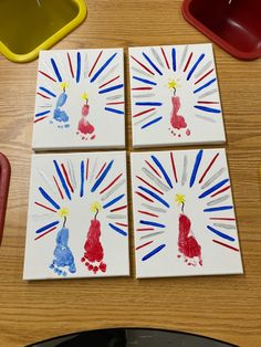 four handprints with red, white and blue designs on them sitting on a table