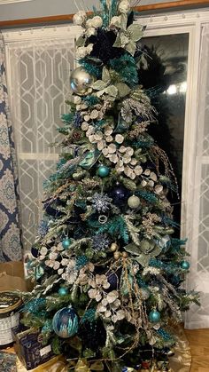 a christmas tree decorated with blue and silver ornaments