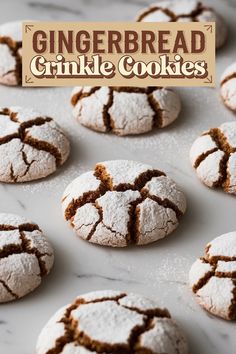 gingerbread crinkle cookies on a baking sheet with powdered sugar in the middle