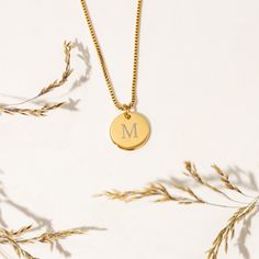 Looking for a special piece of jewelry that's both elegant and personalized? Look no further than this beautiful initial coin necklace that's customized with your chosen initial! PREMIUM MATERIAL -- Made from premium stainless steel and 14K Gold, and designed to last. This necklace is both tarnish-resistant and hypoallergenic, so it's perfect for sensitive skin. PERSONALIZED TAG -- Perfect for anyone who loves to express their individuality through their accessories.  Note: If a font is not given, you will receive the font that is pictured for your order which is font #1. FANCY DESIGN --  Designed for creating a truly fancy and one-of-a-kind piece. Engraved into coin pendants and creates a classy high-class look impression, which is perfect to wear every day on any occasion. PERFECT FOR HE Classic Yellow Gold Initial Necklace For Anniversary, Classic Round Pendant Jewelry With Initials, Classic Initials Name Necklace For Anniversary, Classic 14k Stamped Initial Necklace For Anniversary, Initial Pendant Charm Necklaces For Anniversary, Anniversary Gift Initial Pendant Charm Necklaces, Classic Yellow Gold Charm Necklaces With Initials, Classic Name Necklace For Anniversary, Dainty Initials Necklace For Anniversary