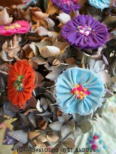 there are many different flowers on this table cloth, and one is blue with orange centers